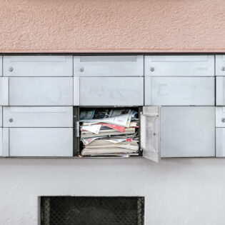 mailbox full of newspapers